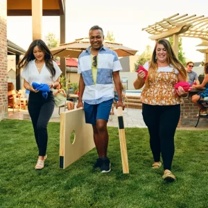 about-community-home-comfort-services-llc-bear-de Three friends walking forward setting up a cornhole game